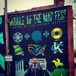 in front of the Middle of the Map Fest mural
